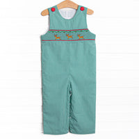 This bubble features a green gingham print, red covered buttons, and a reindeer smockings.