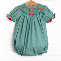  This bubble features a green gingham print, puff sleeves, and a reindeer smockings. 