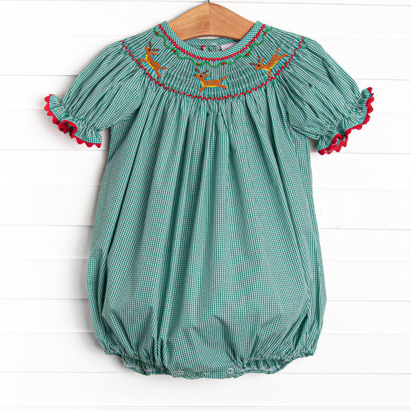  This bubble features a green gingham print, puff sleeves, and a reindeer smockings. 