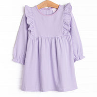 The dress features ruffle trim, purple stripes, and soft knit material.