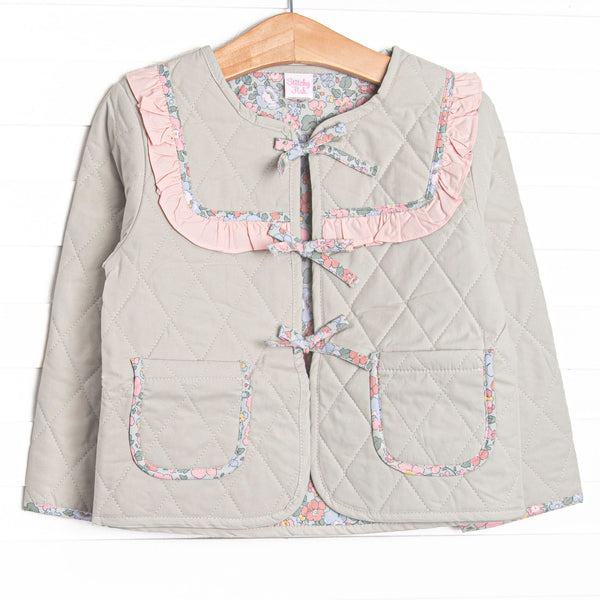 This jacket features sage fabric, floral ruffle trim, a tie front, and front pockets.