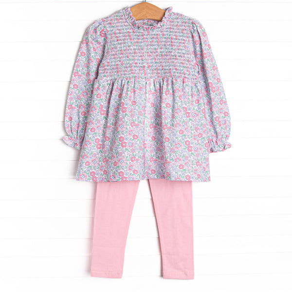 This set features a pink floral print, ruffle trim around the neck, and elastic smocking across the chest. Coordinating pink leggings to match.