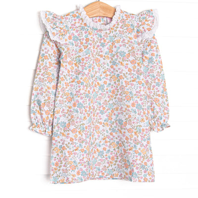  This dress features a blue floral print, eyelet lace trim, and long sleeves. 