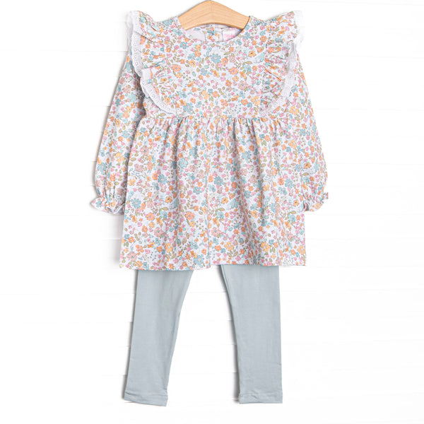 This set features a blue floral print, eyelet lace trim, and blue leggings to match.