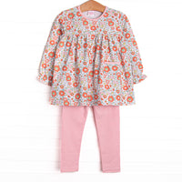  This set features a pink floral print, front pocket, and pink leggings to match. 