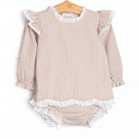 This set features a tan gingham print, an eyelet trim, and scalloped edges. Coordinating diaper cover to match.