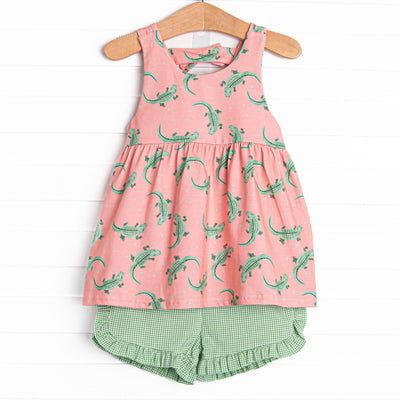  This set features a coral gator print, a bow on the back, and green ruffle shorts to match. 