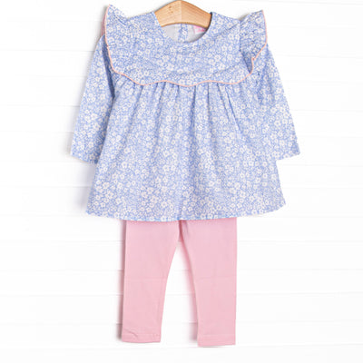  This set features a blue floral print, a ruffle bib with pink trim, and pink leggings to match. 