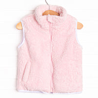  This vest features the softest pink fuzzy fleece, pockets to keep little hands warm, and a full zipper down the front. 
