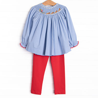 This set features a blue gingham print, red picot trim, and a santa sleigh smocking. Coordinating red leggings to match.