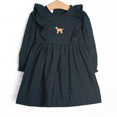  This dress features navy and green plaid, ruffle trim, and puppy embroidery. 