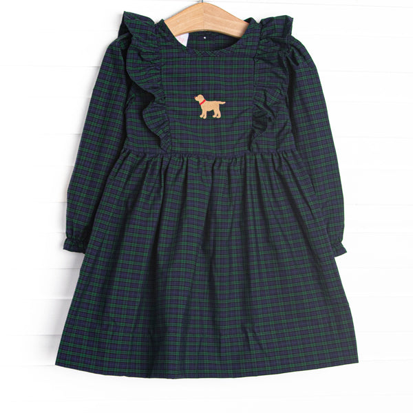  This dress features navy and green plaid, ruffle trim, and puppy embroidery. 