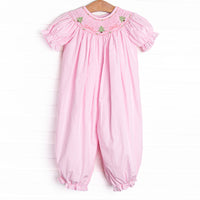  This romper features a pink gingham print, puff sleeves, and a trio of Christmas tree smockings. 