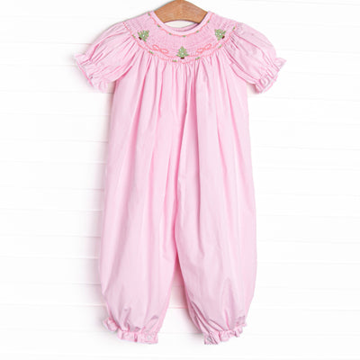  This romper features a pink gingham print, puff sleeves, and a trio of Christmas tree smockings. 