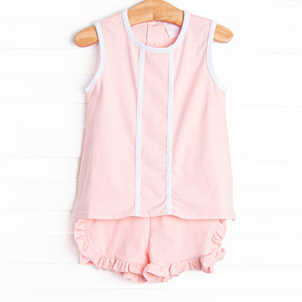  This set features a pink knit material, white trim, and ruffle shorts to match. 