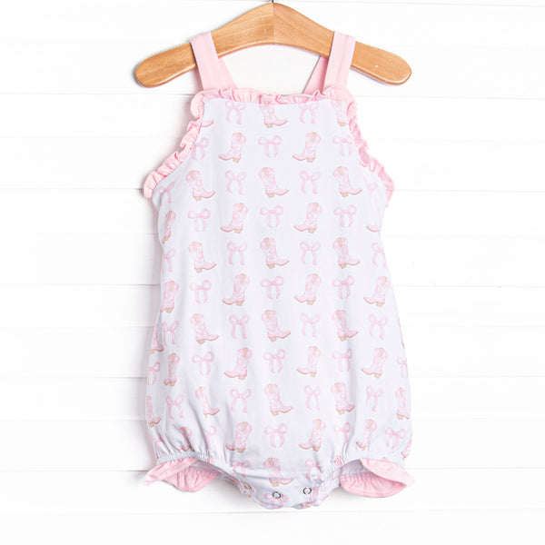  This bubble features a pink cowgirl boots print, pink ruffle trim and pink bow back. 