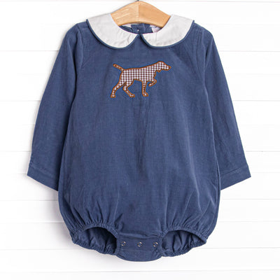 This bubble features a Navy Corduroy material, a peter pan collar, and a puppy applique.