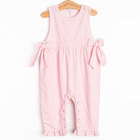  Featured in a soft pink color, with bow details on the sides and snaps along the stride. 