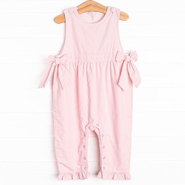  Featured in a soft pink color, with bow details on the sides and snaps along the stride. 