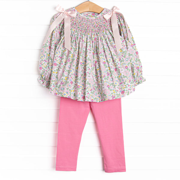 A long sleeve top with a pink smocking and pink bow details on the shoulders. Coordinating pink leggings to match.