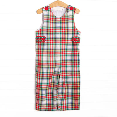  This Jon Jon features a red plaid print, red covered buttons, and smocked tabs on the sides. 