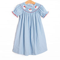 This dress features a blue corduroy material, puff sleeves with red picot trim, and Santa Claus smockings.