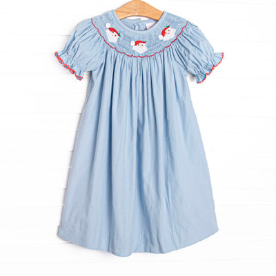 This dress features a blue corduroy material, puff sleeves with red picot trim, and Santa Claus smockings.