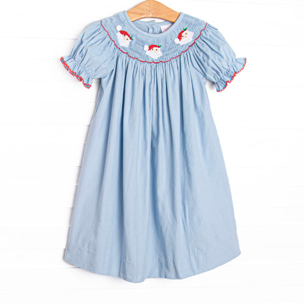 This dress features a blue corduroy material, puff sleeves with red picot trim, and Santa Claus smockings.