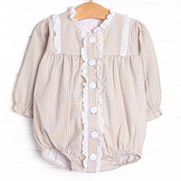 This bubble features a tan gingham print, an eyelet trim, and buttons down the front.