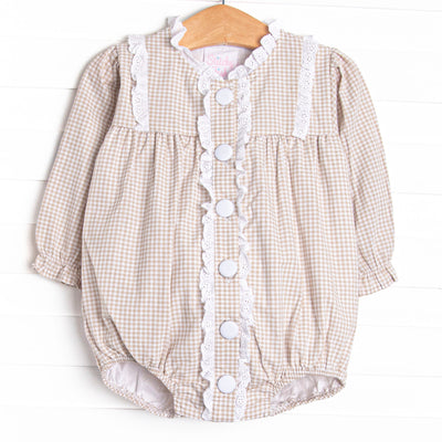 This bubble features a tan gingham print, an eyelet trim, and buttons down the front.