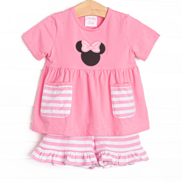 A bright pop of pink, coupled with pink and white striped pockets has us ready for a magical adventure. A mouse ears applique with a whimsical polka dot bow adorns the front of this set. Coordinating striped ruffle shorts to match.