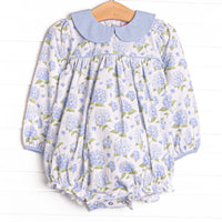  This bubble features a blue hydrangea print, blue peter pan collar, and snaps on the stride. 