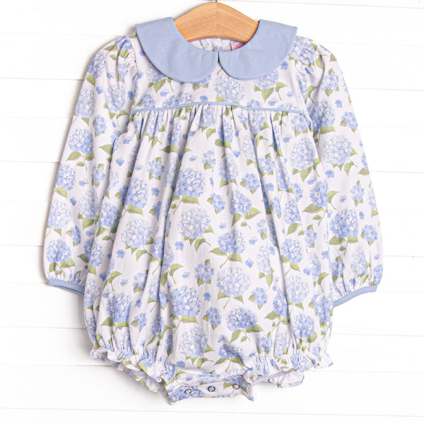  This bubble features a blue hydrangea print, blue peter pan collar, and snaps on the stride. 