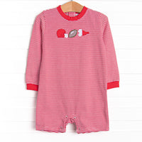  This romper features a red striped print, snaps on the stride, and a football applique. 