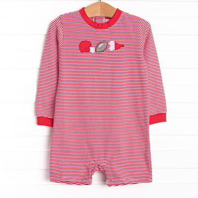  This romper features a red striped print, snaps on the stride, and a football applique. 