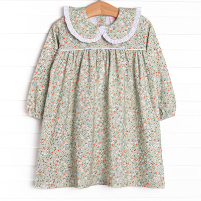 This dress features a green floral print, a peter pan collar with white ruffle trim, and the softest knit material.