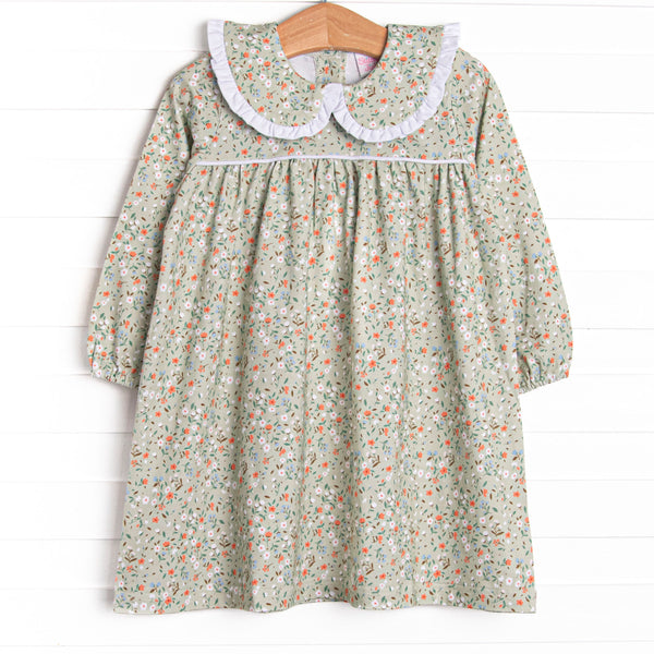 This dress features a green floral print, a peter pan collar with white ruffle trim, and the softest knit material.
