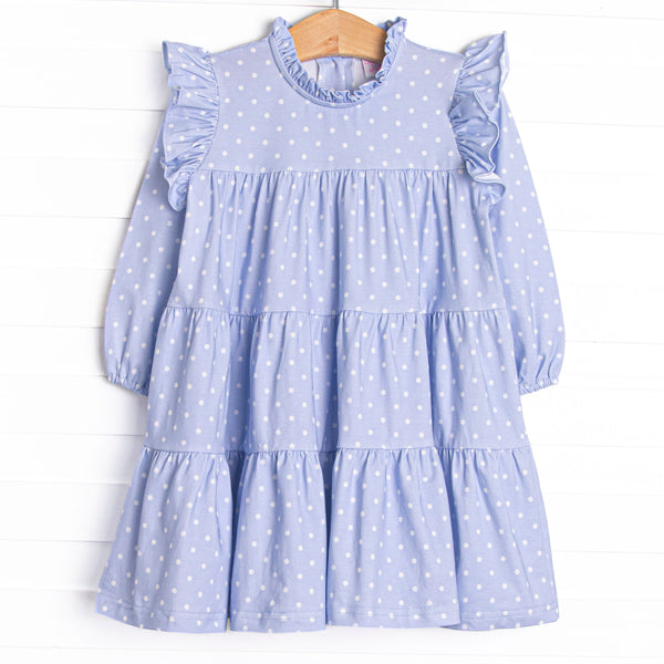 This dress features periwinkle polka dots, a ruffle trim, and tiered ruffles.