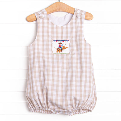  This bubble features a tan check print, a cowboy smocking, and snaps on the stride. 