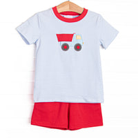This set features a blue striped print, red trim, and a dump truck applique. Coordinating red shorts to match.