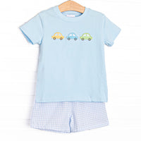 This set&nbsp; features a royal blue short sleeve top with trio of cars smockings and blue gingham shorts to match