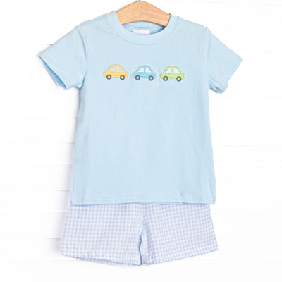 This set&nbsp; features a royal blue short sleeve top with trio of cars smockings and blue gingham shorts to match