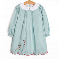 This dress features a green gingham print, a peter pan collar, and reindeer embroidery.