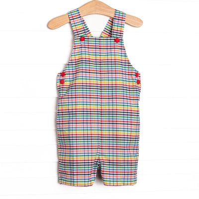 This jon jon features a plaid print, snaps on the stride, and red buttons