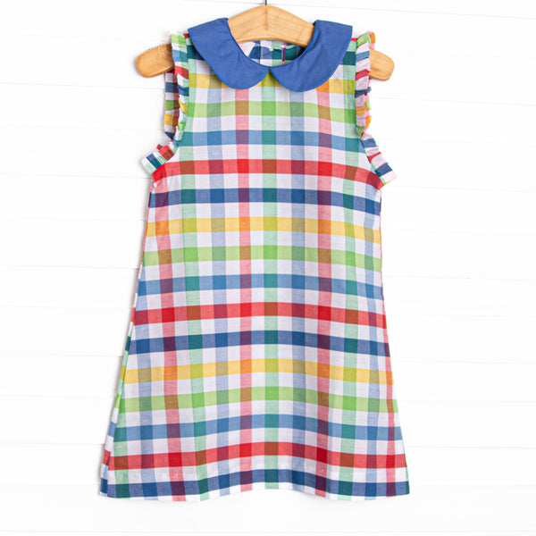 This dress features a&nbsp; primary color check print, a blue peter pan collar and ruffle trim