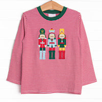 This top features a red striped print, green trim, and a trio of toy soldiers applique.