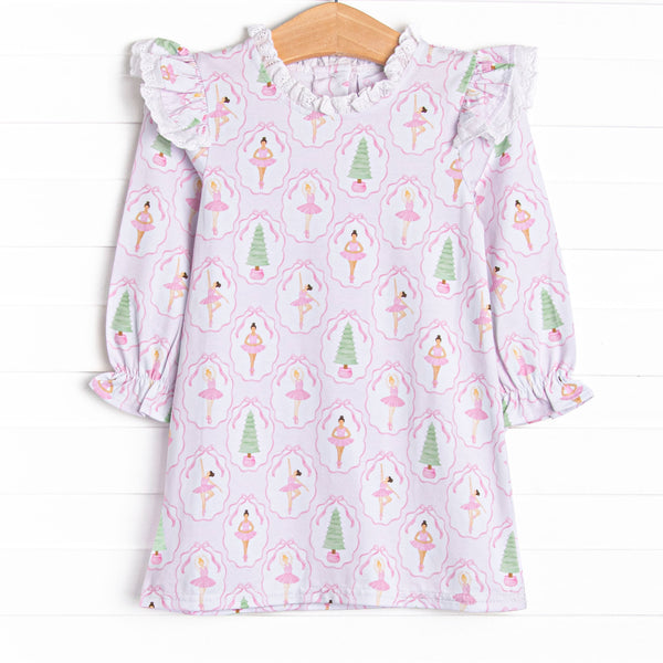 This dress features a holiday print, ruffle shoulders, and eyelet lace trim.