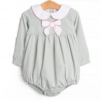  This bubble features a sage gingham print, a bow collar with pink ric rac trim, and snaps on the stride. 