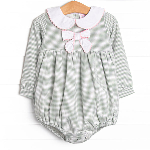  This bubble features a sage gingham print, a bow collar with pink ric rac trim, and snaps on the stride. 
