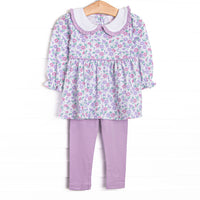 This set features a lavender floral print, a peter pan collar with ruffle trim, and purple leggings to match. 